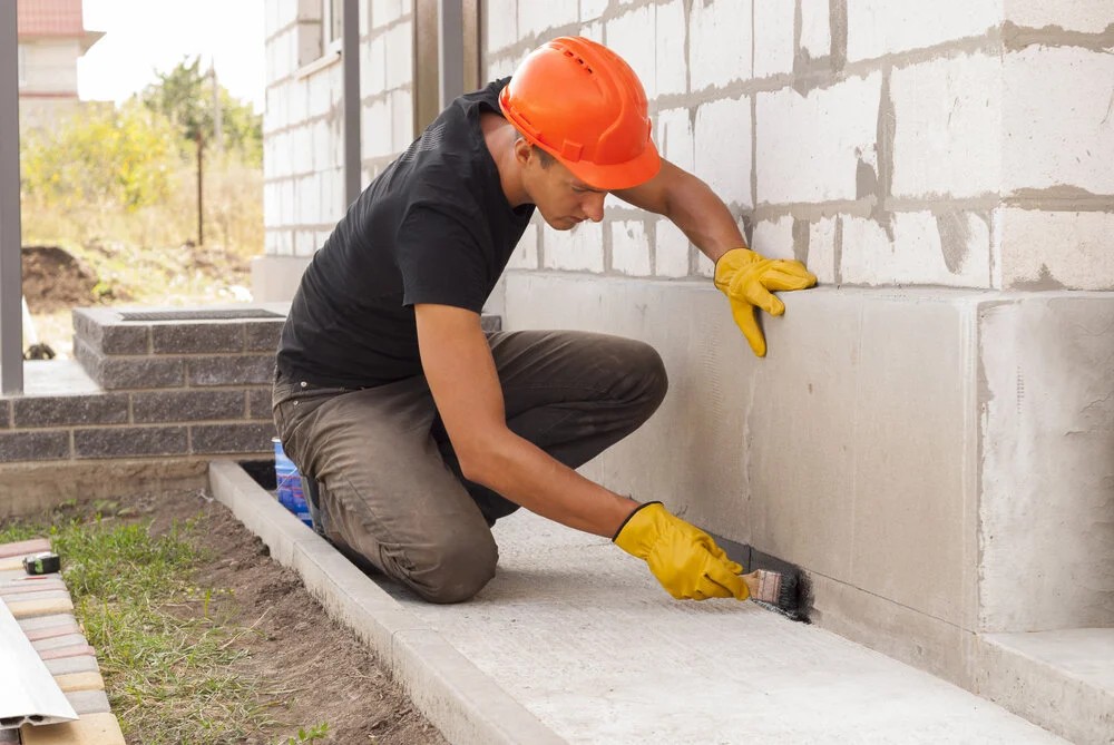 Foundation repair in Austin, TX — local crew taking elevation readings inside a Central Austin home