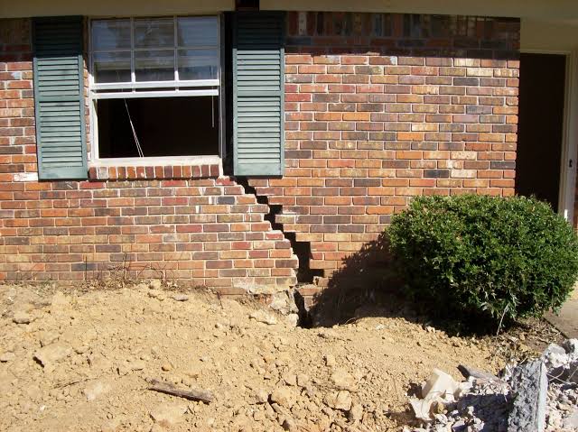 Foundation repair in Austin, TX — steel pier installation alongside an East Austin bungalow on a clay soil lot